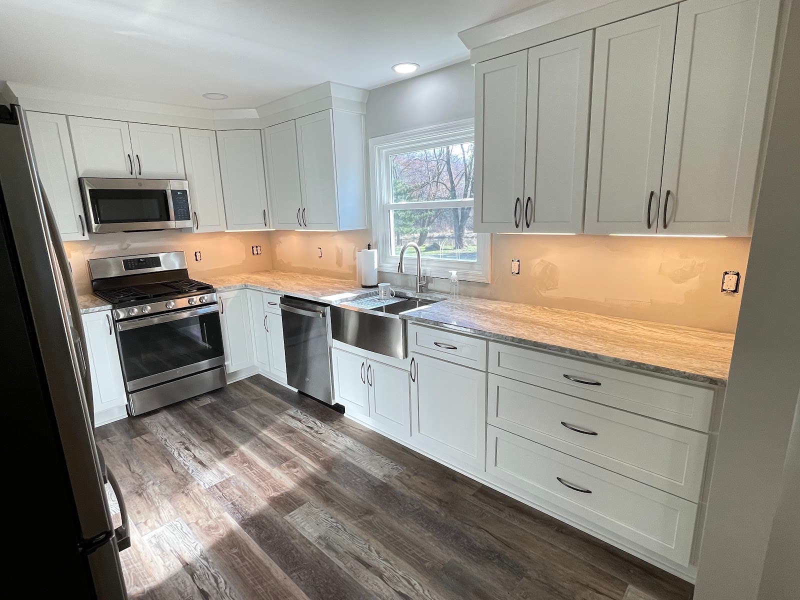 Kitchen renovation with custom cabinetry, granite countertops, and hardwood floors in Northeast Ohio