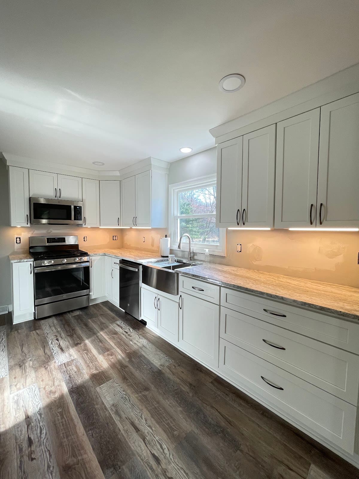 Full kitchen remodel with updated cabinets, stone countertops, and tile backsplash in Lake County Ohio