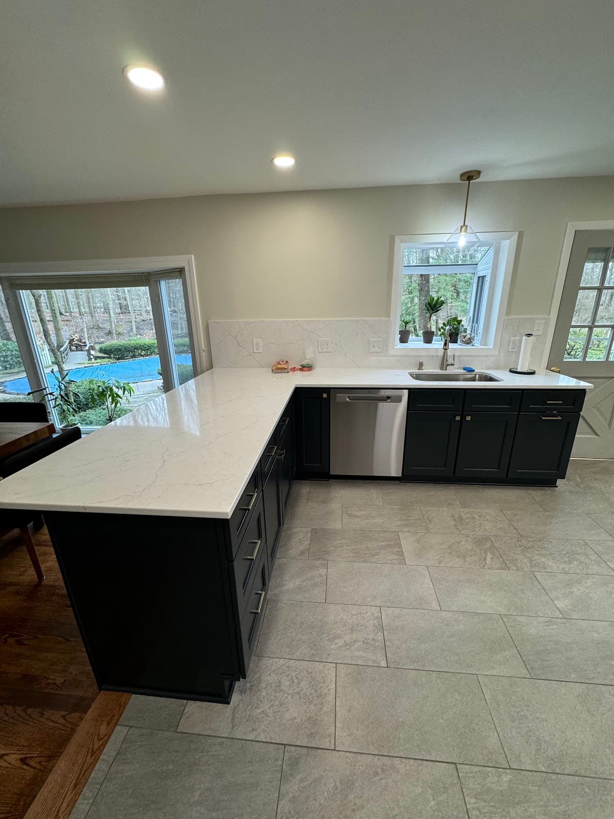 Full kitchen renovation with updated shaker cabinets, stone countertops, and tile backsplash in Northeast Ohio