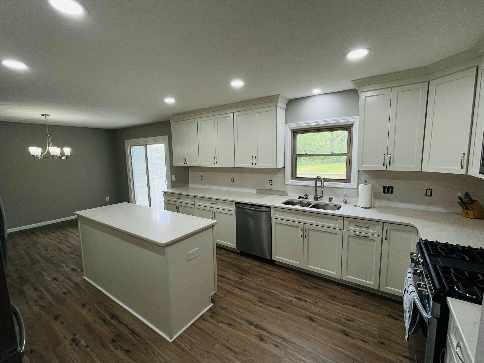 Full kitchen renovation with premium cabinetry, quartz island, and tile backsplash in Lake County Ohio