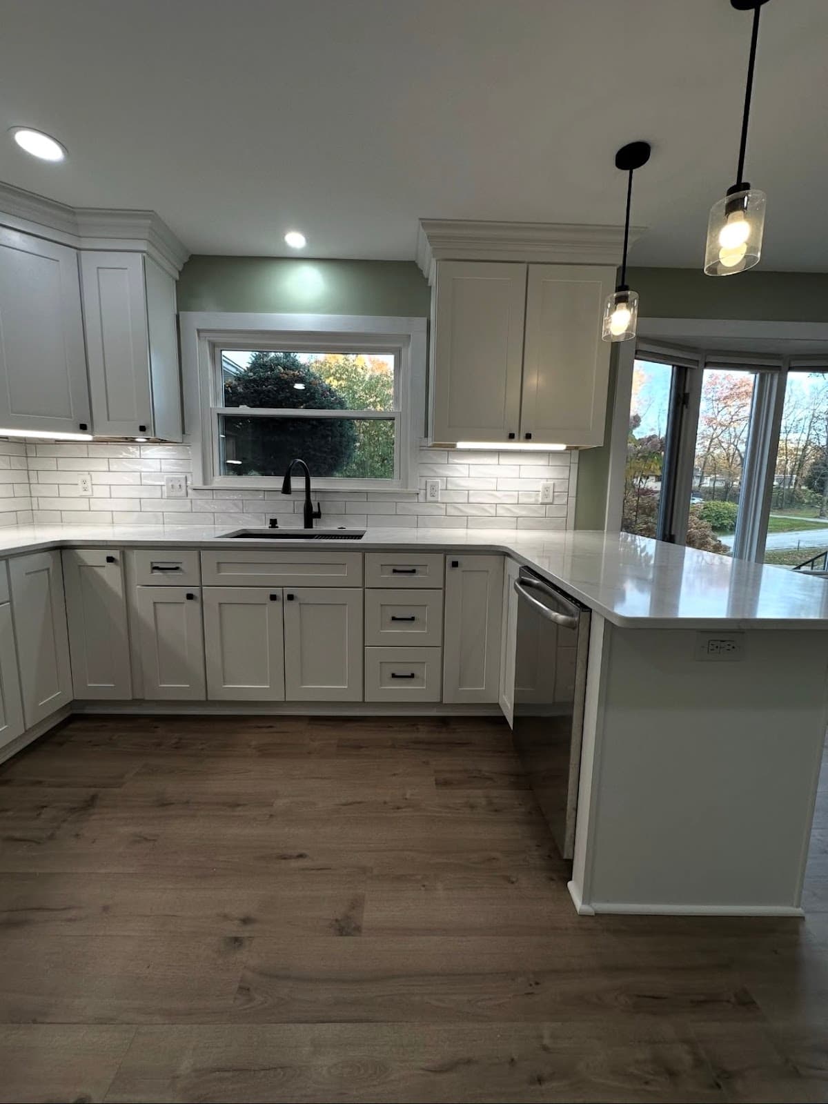 Kitchen remodel with custom shaker cabinets, stone countertops, and premium fixtures in Northeast Ohio