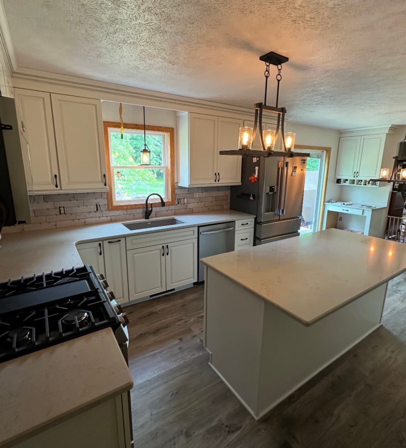 Kitchen renovation with shaker cabinetry, stone countertops, and hardwood floors in Northeast Ohio