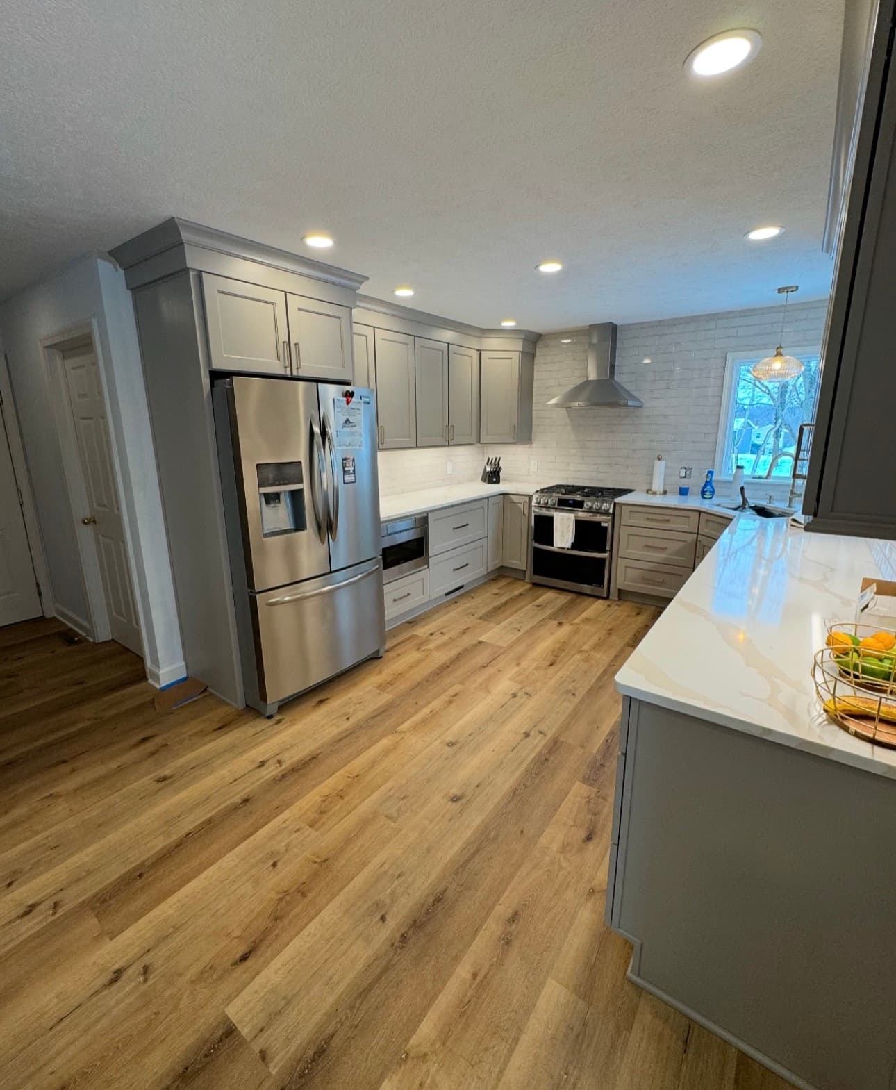 Kitchen remodel with custom cabinetry, premium countertops, and tile backsplash in Lake County Ohio