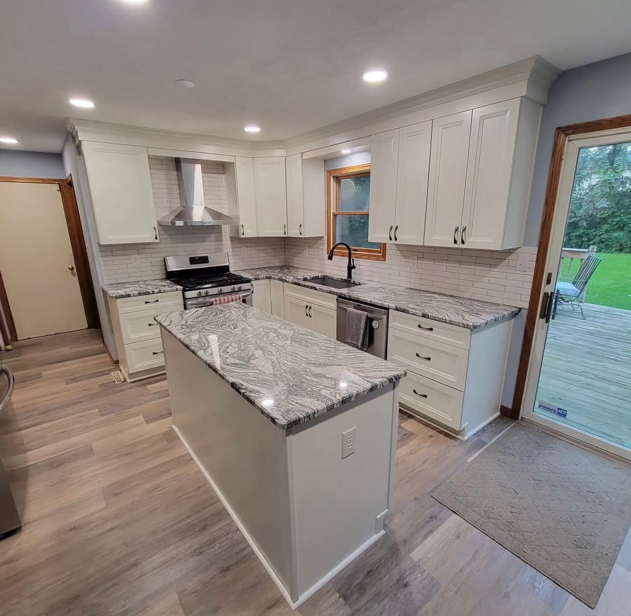 Kitchen renovation with custom cabinetry, quartz countertops, and recessed lighting in Northeast Ohio