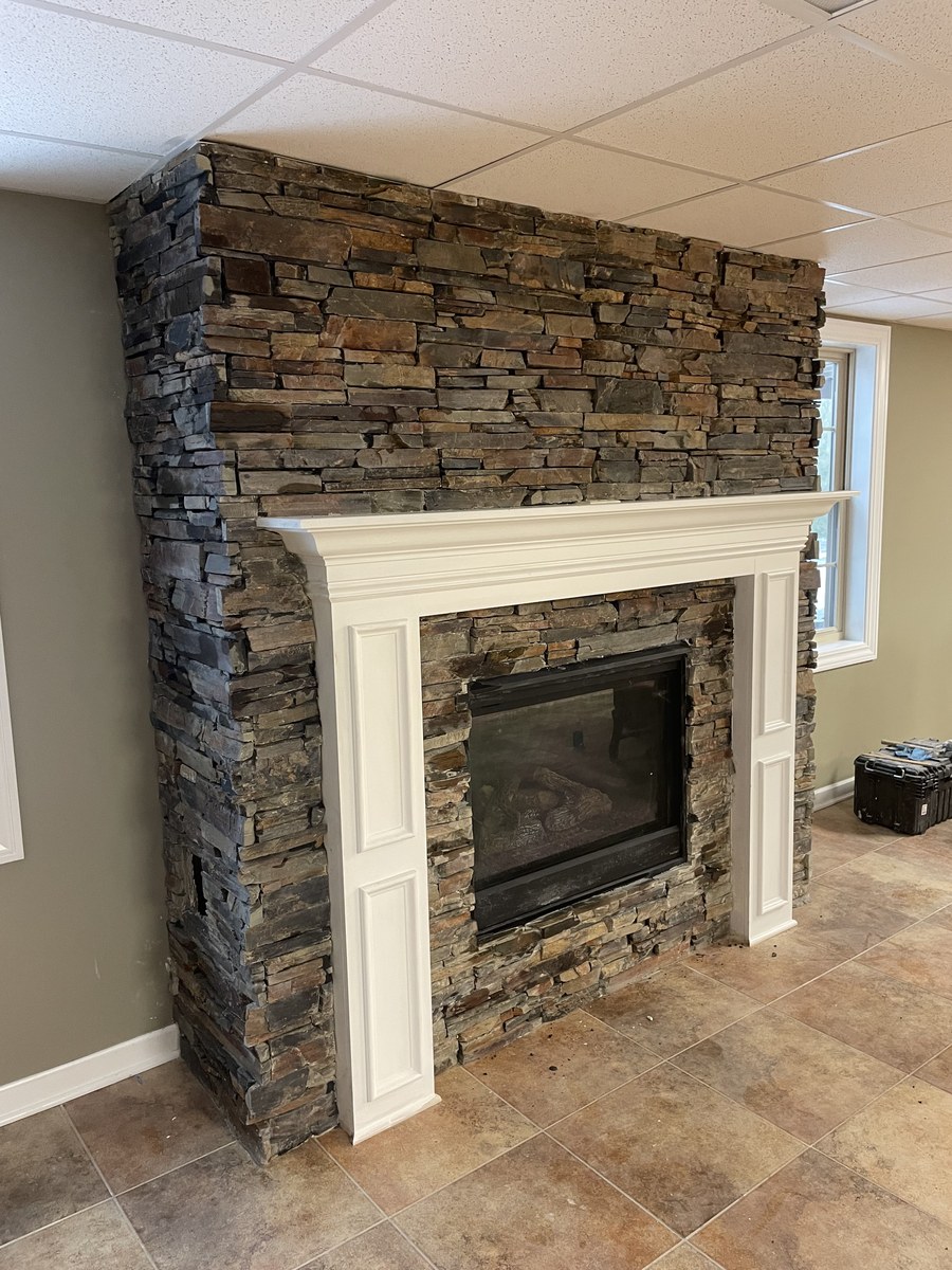 Light ledger stone fireplace with wood beam mantel