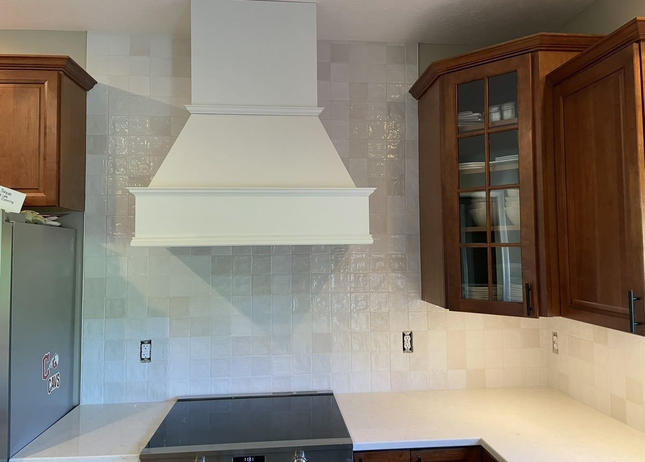 Full kitchen renovation with custom cabinetry and stone backsplash